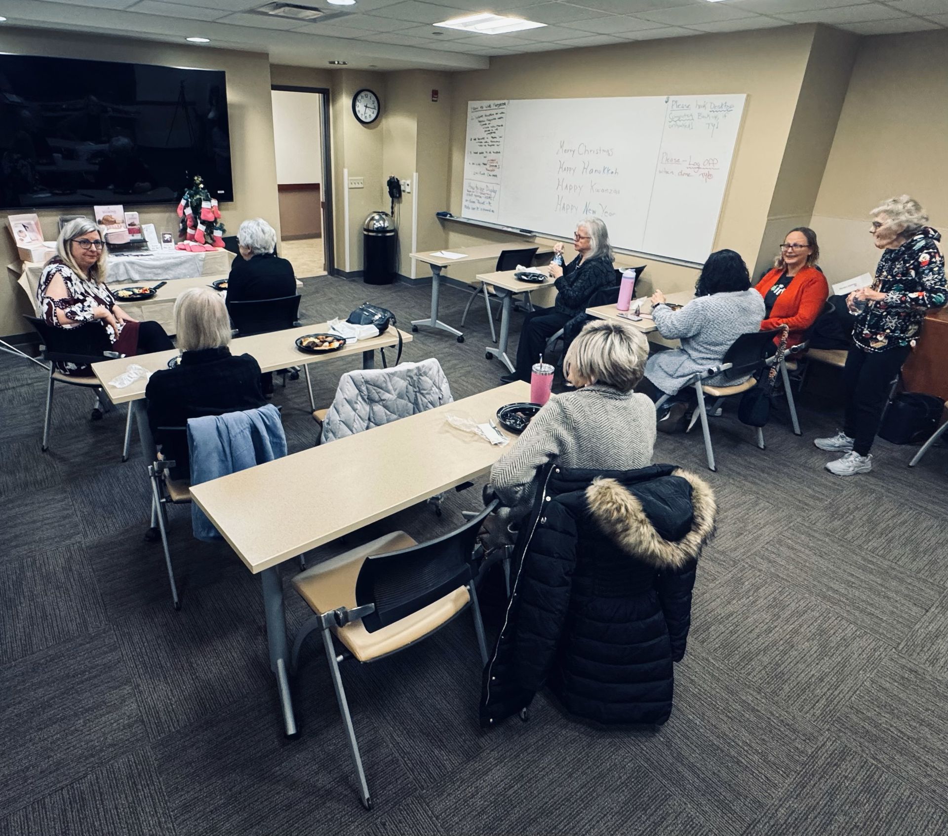A group of people are sitting at tables in a room.