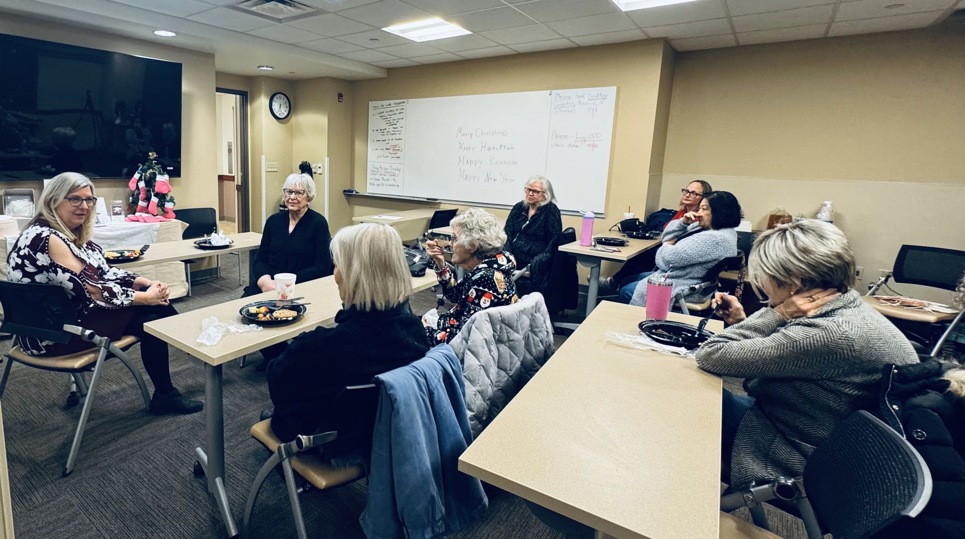 A group of people are sitting at tables in a room.