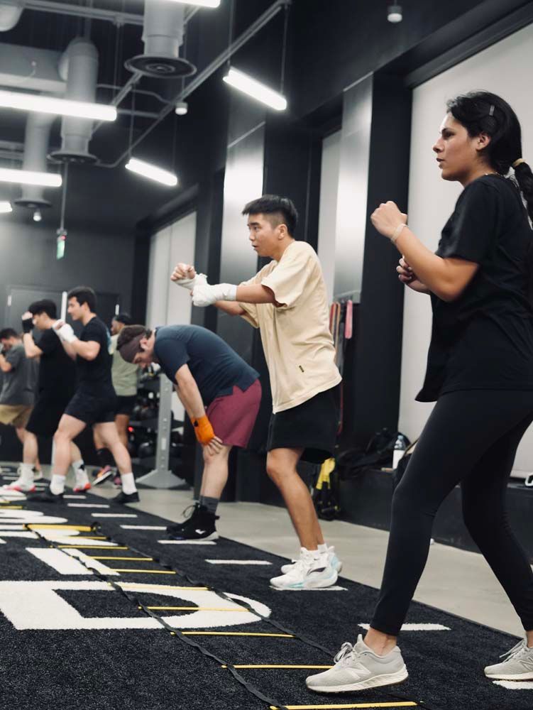 A group of people are doing exercises in a gym