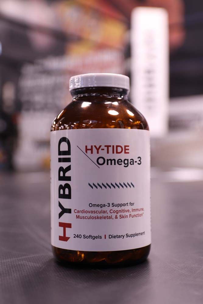 A bottle of hybrid hy-tide omega 3 is sitting on a table.
