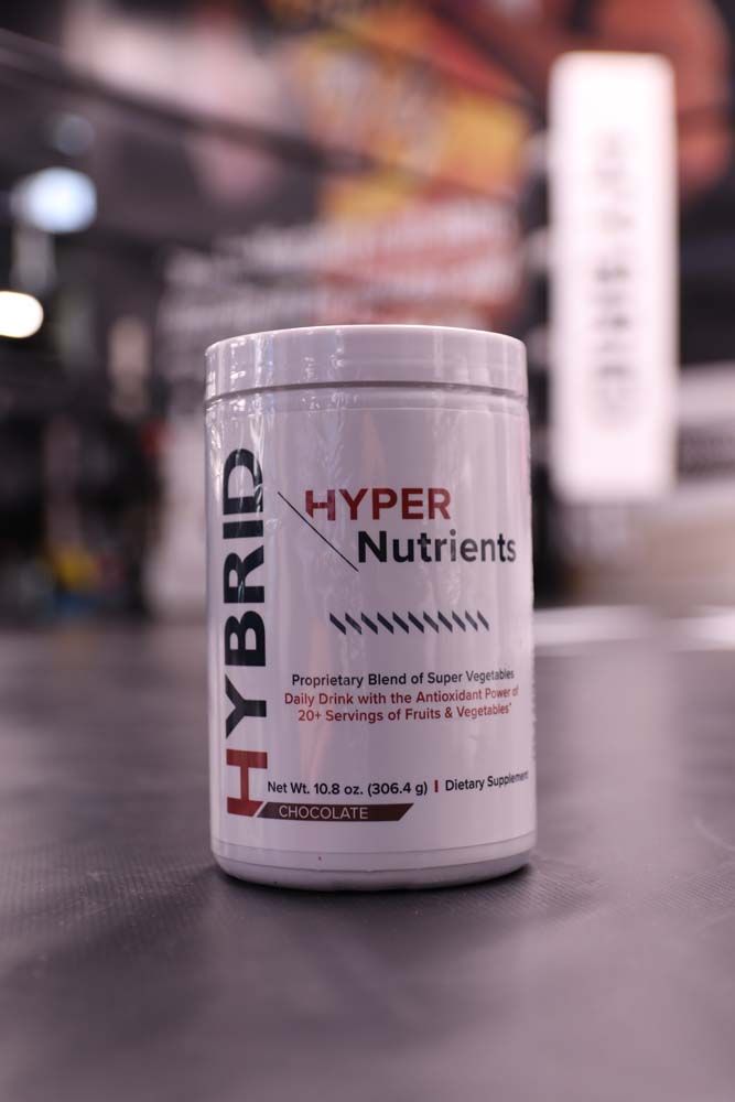 A bottle of hybrid hyper nutrients is sitting on a table.