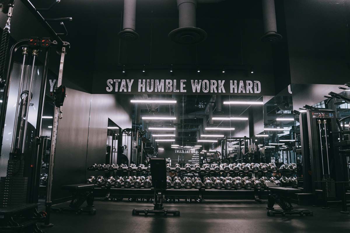 A gym with a sign that says `` stay humble work hard ''.