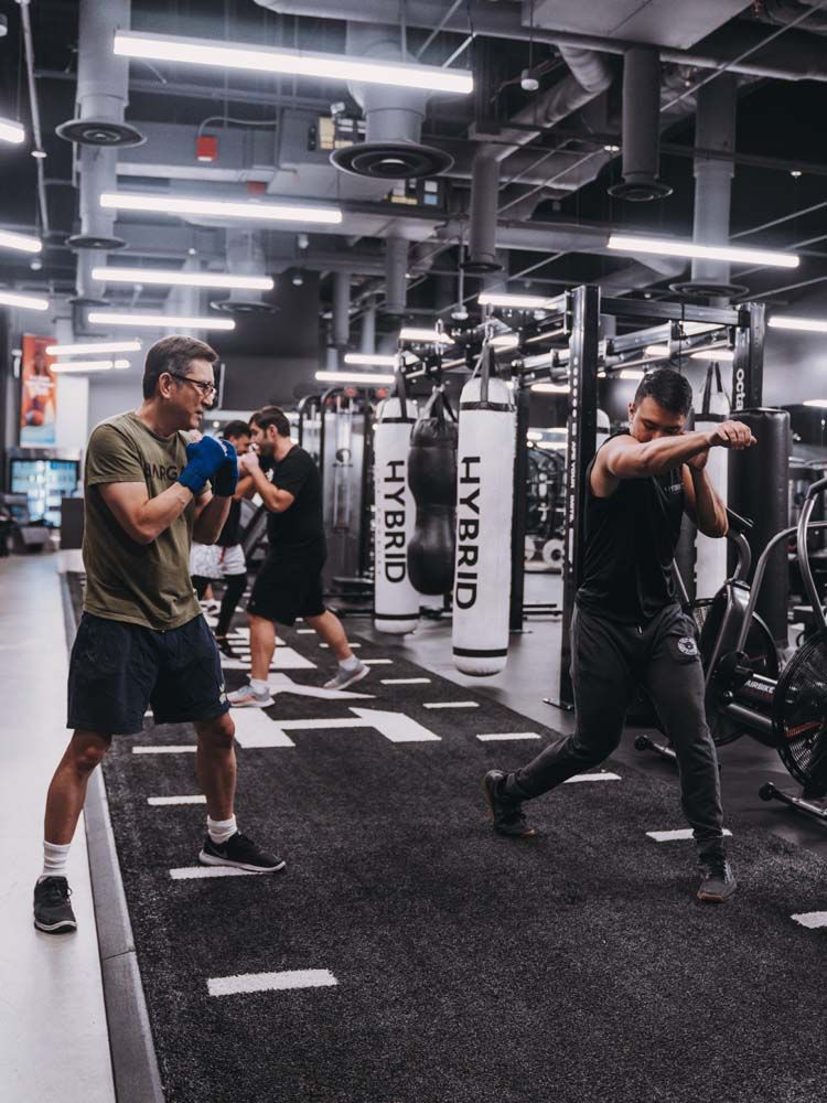 A group of men are boxing in a gym.