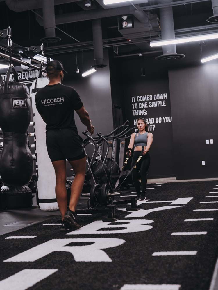 A man in a black shirt with the word coach on it