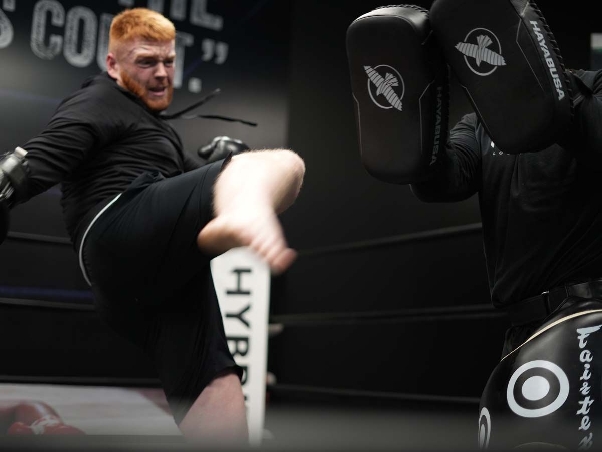 A man kicking a paddle that says hype on it