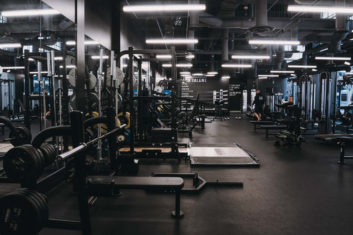 An empty gym with a lot of equipment and a lot of lights.