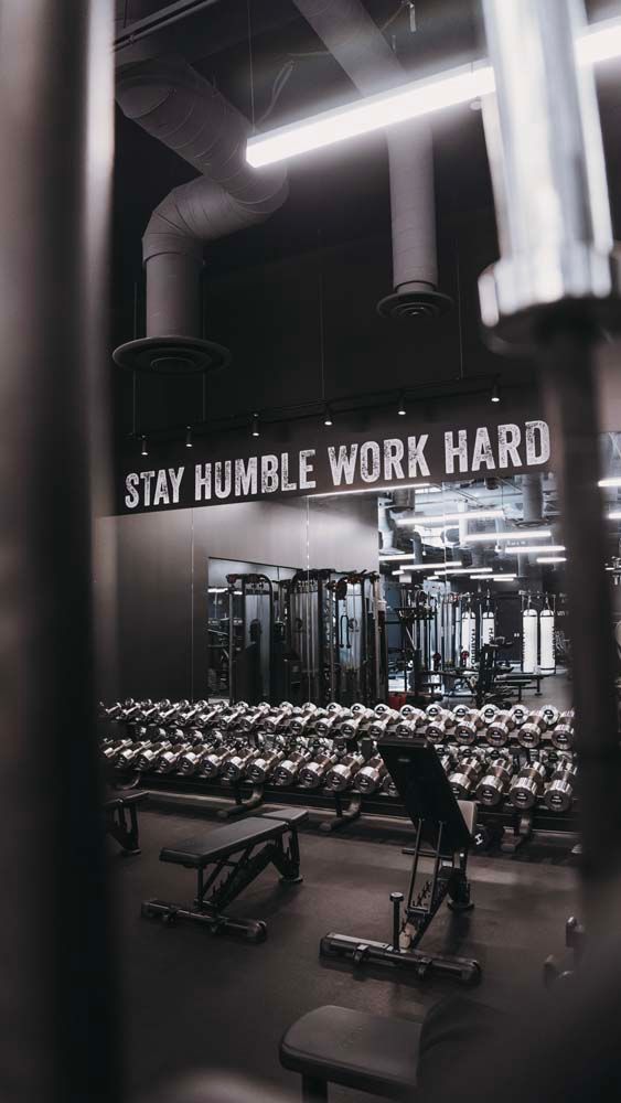 A gym with a sign that says `` stay humble work hard ''.