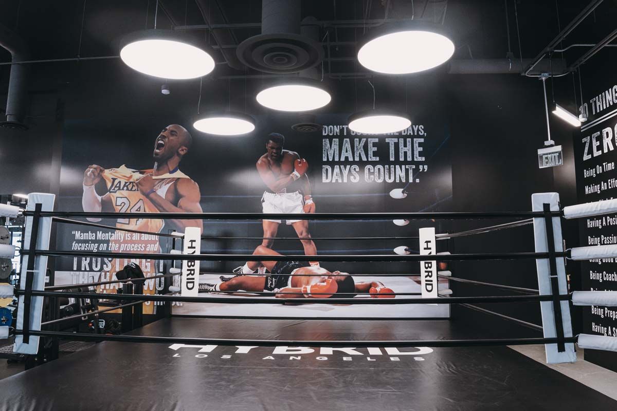 A boxing ring with a mural on the wall that says make the days count