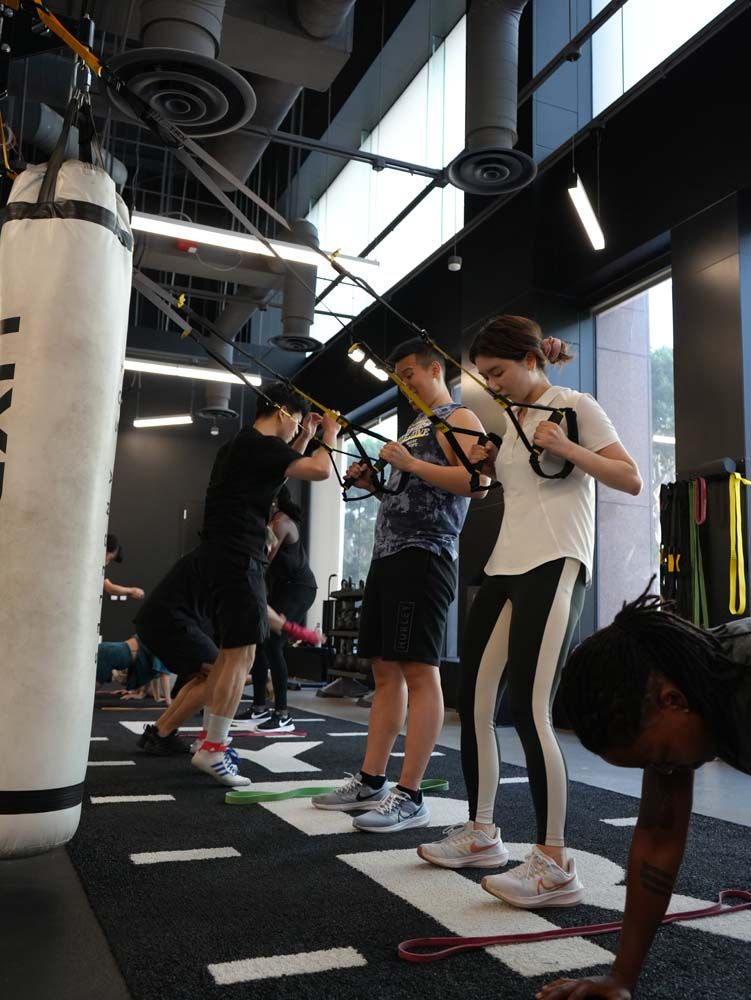 A group of people are doing exercises in a gym.