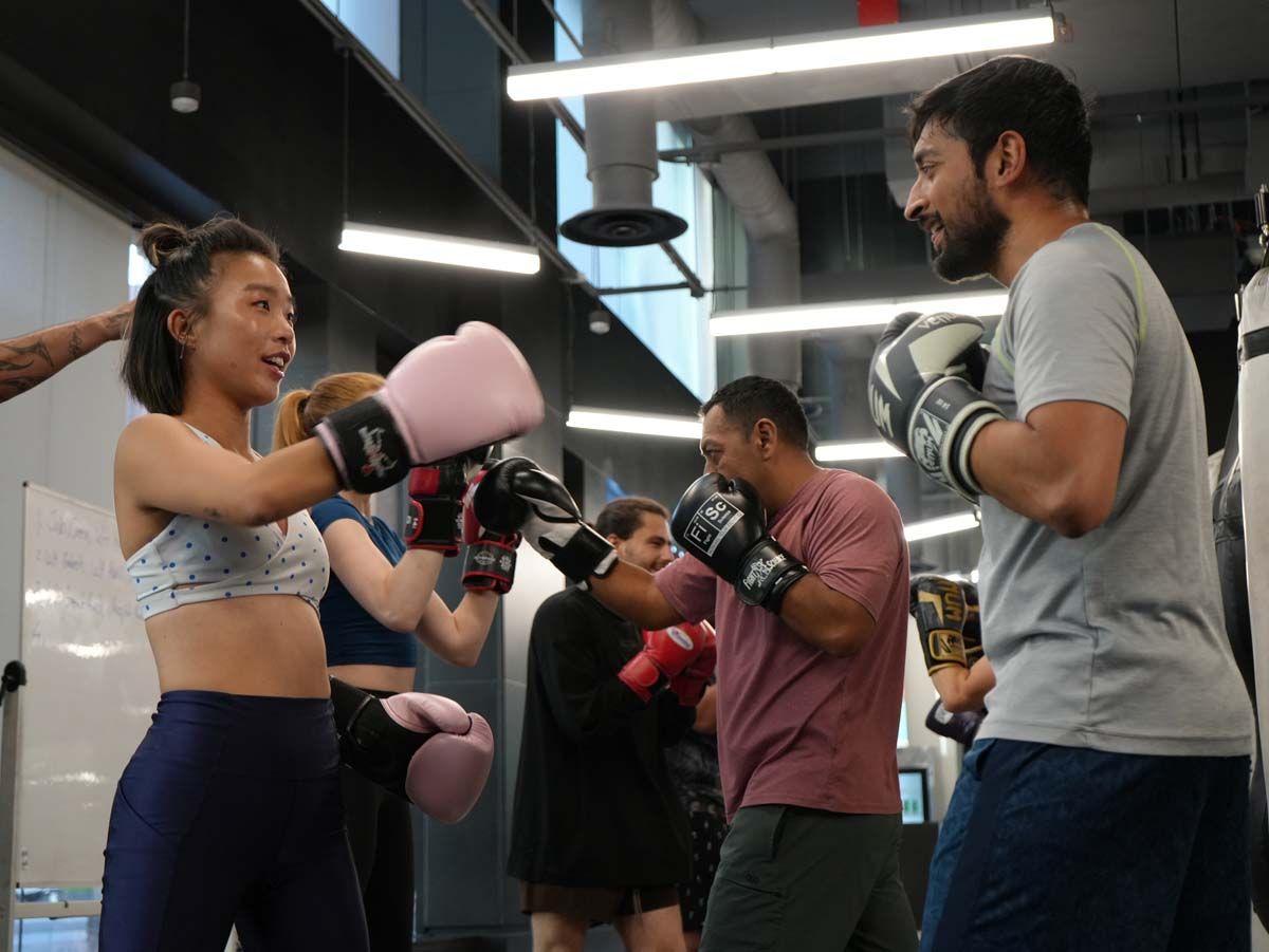 A group of people are boxing in a gym.