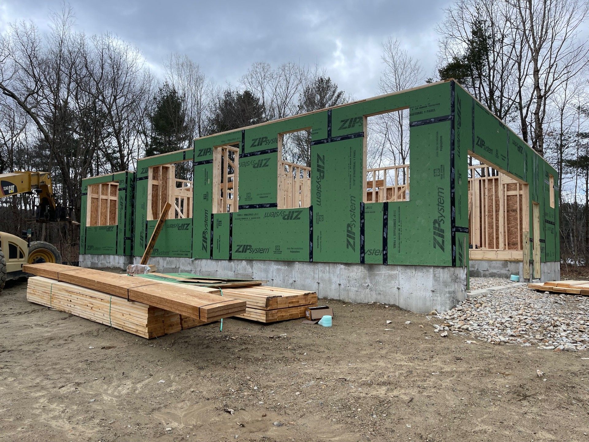 A house is being built in the middle of a dirt field.