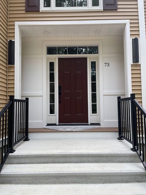 The front door of a house with the number 73 on it