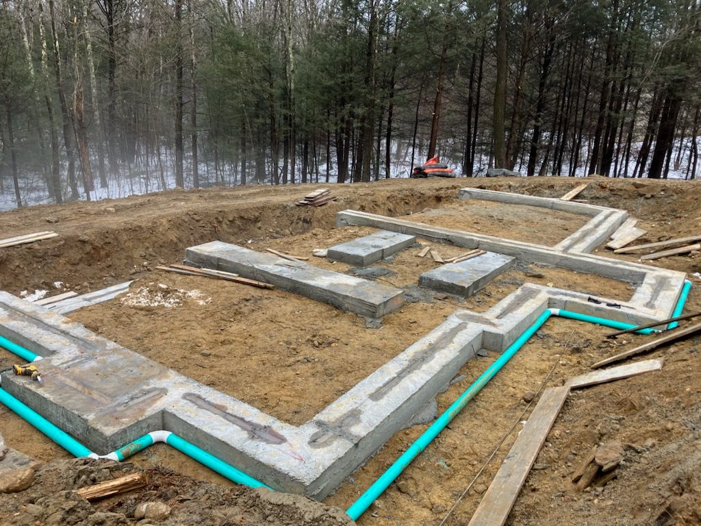 A foundation for a house is being built in the middle of a forest.