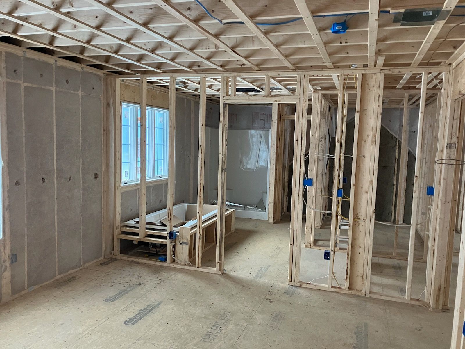 A room in a house under construction with a lot of wooden frames.