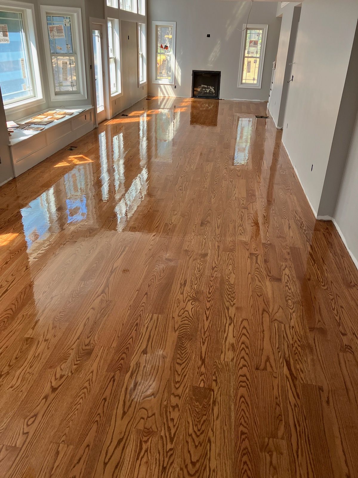 A living room with hardwood floors and a fireplace.