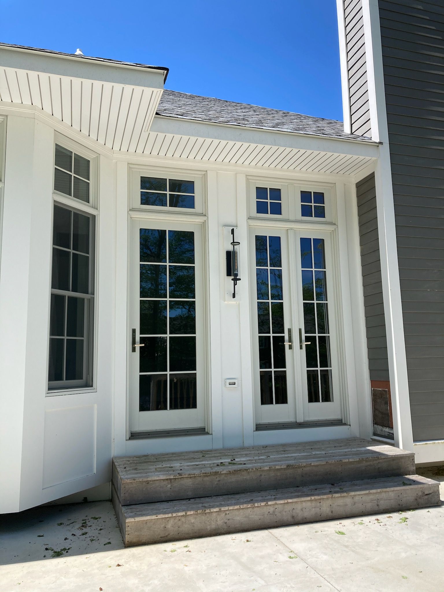 A white house with a blue sky in the background