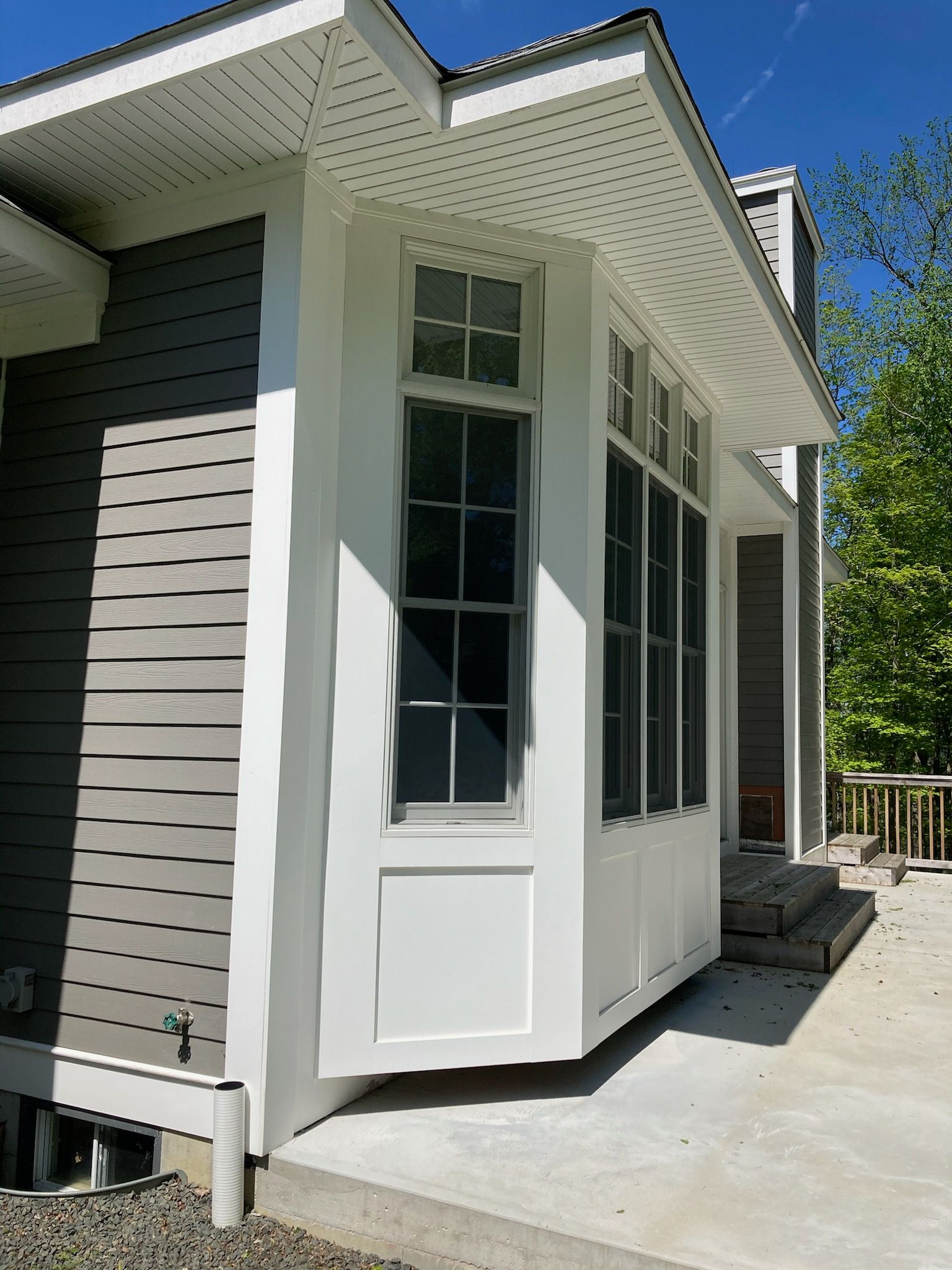 A house with a large window on the side of it.