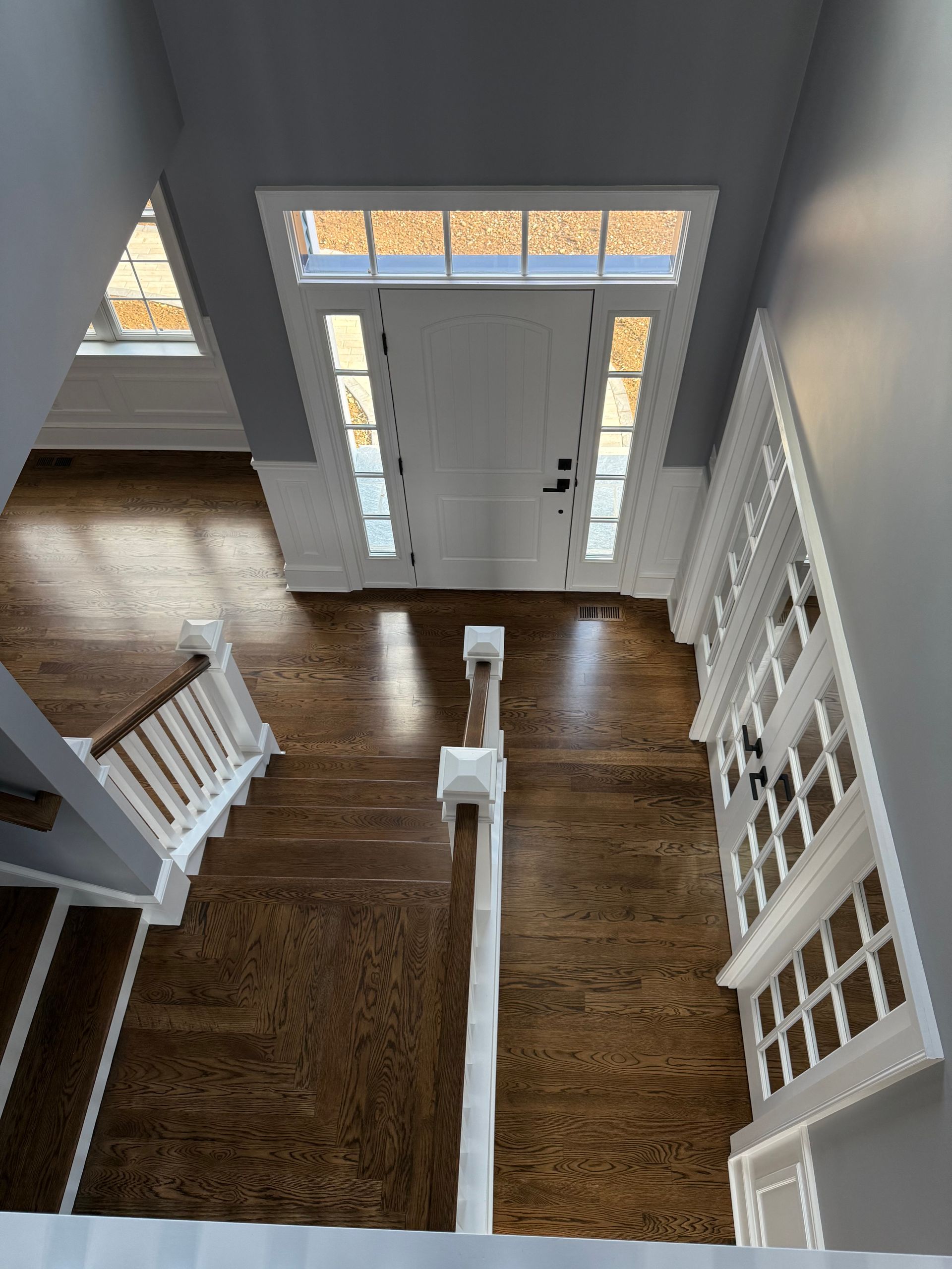 An aerial view of a house with hardwood floors and stairs