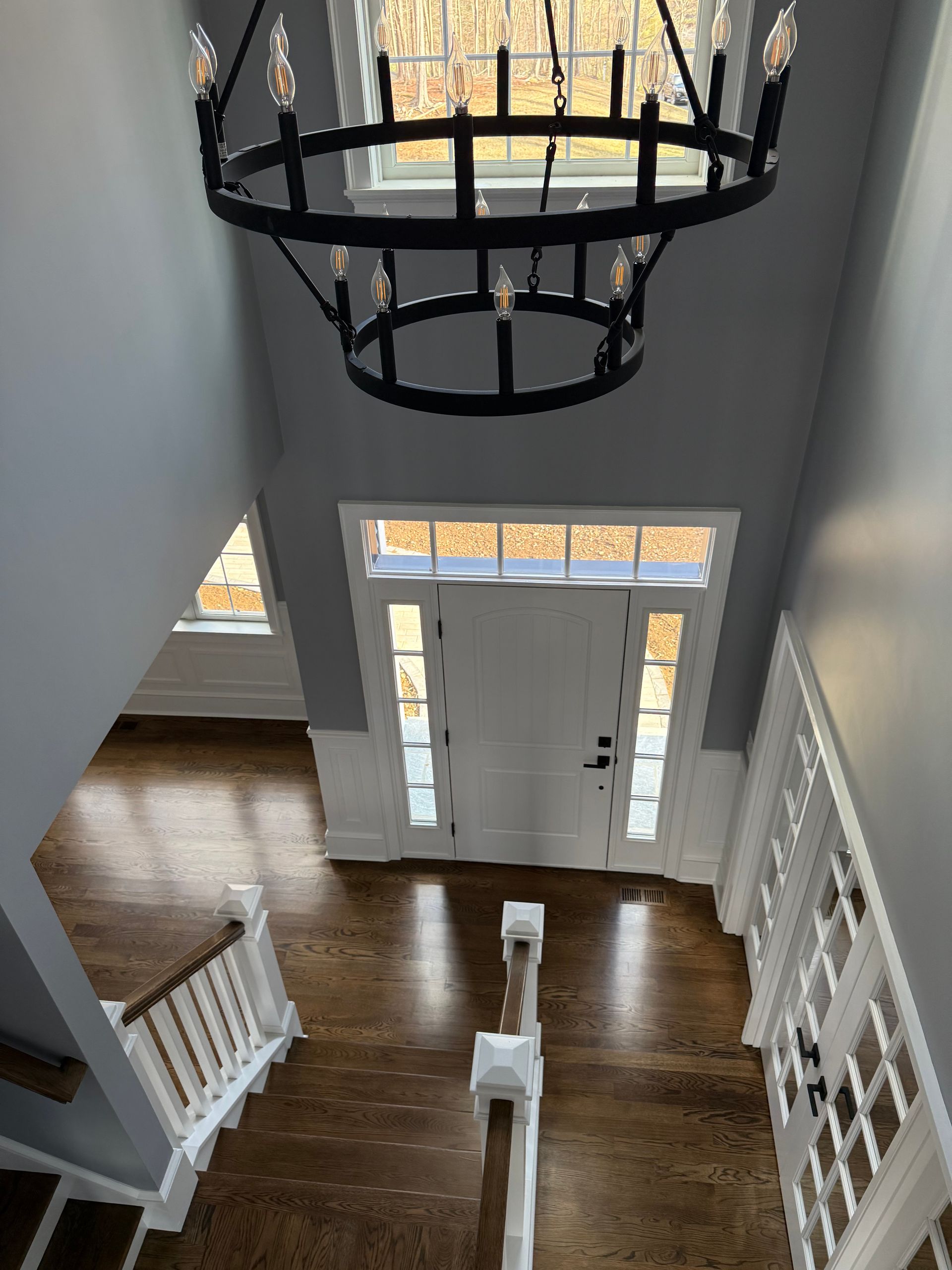 An aerial view of a hallway with a chandelier hanging from the ceiling.