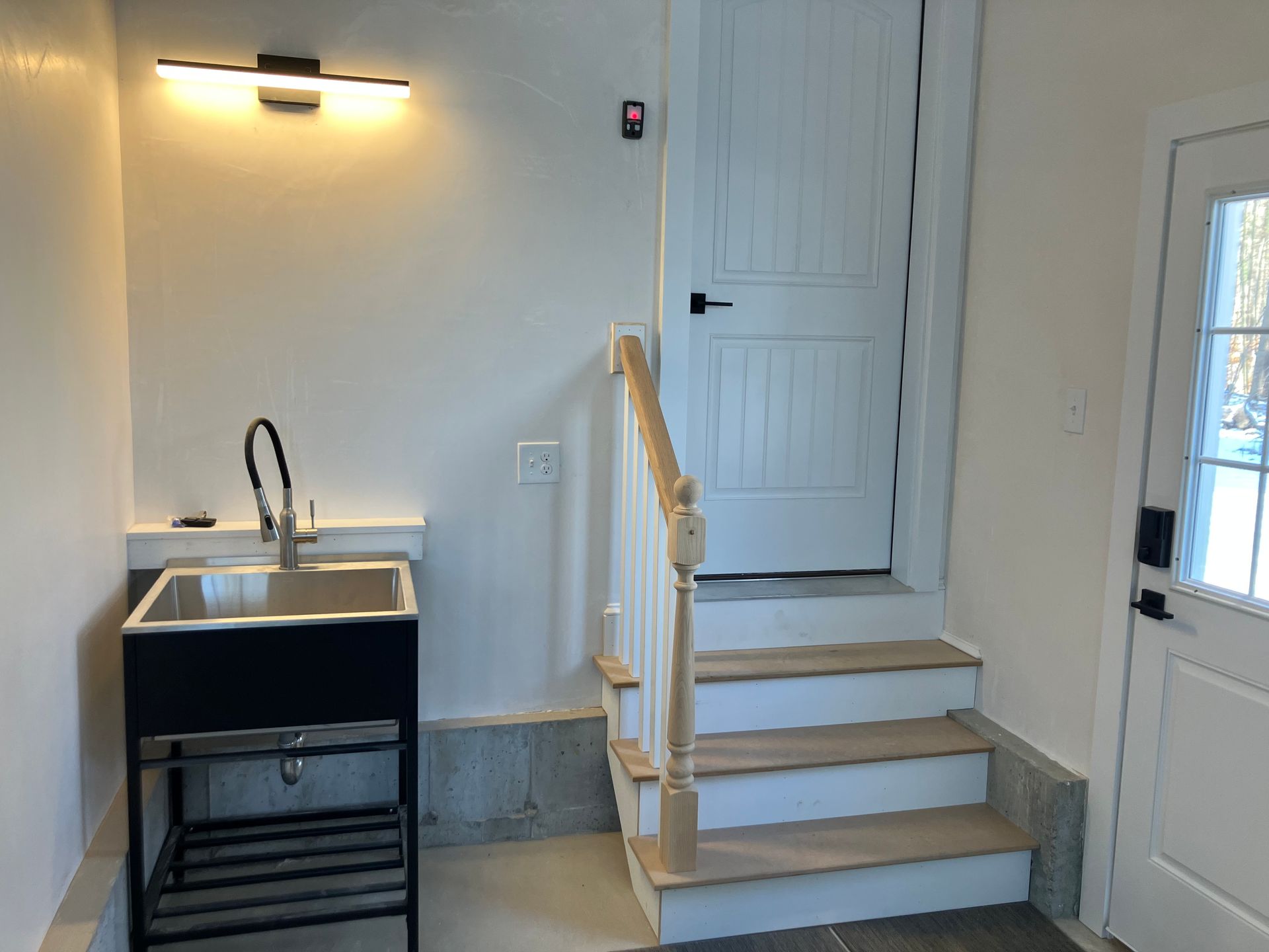 There is a sink and stairs in the room.