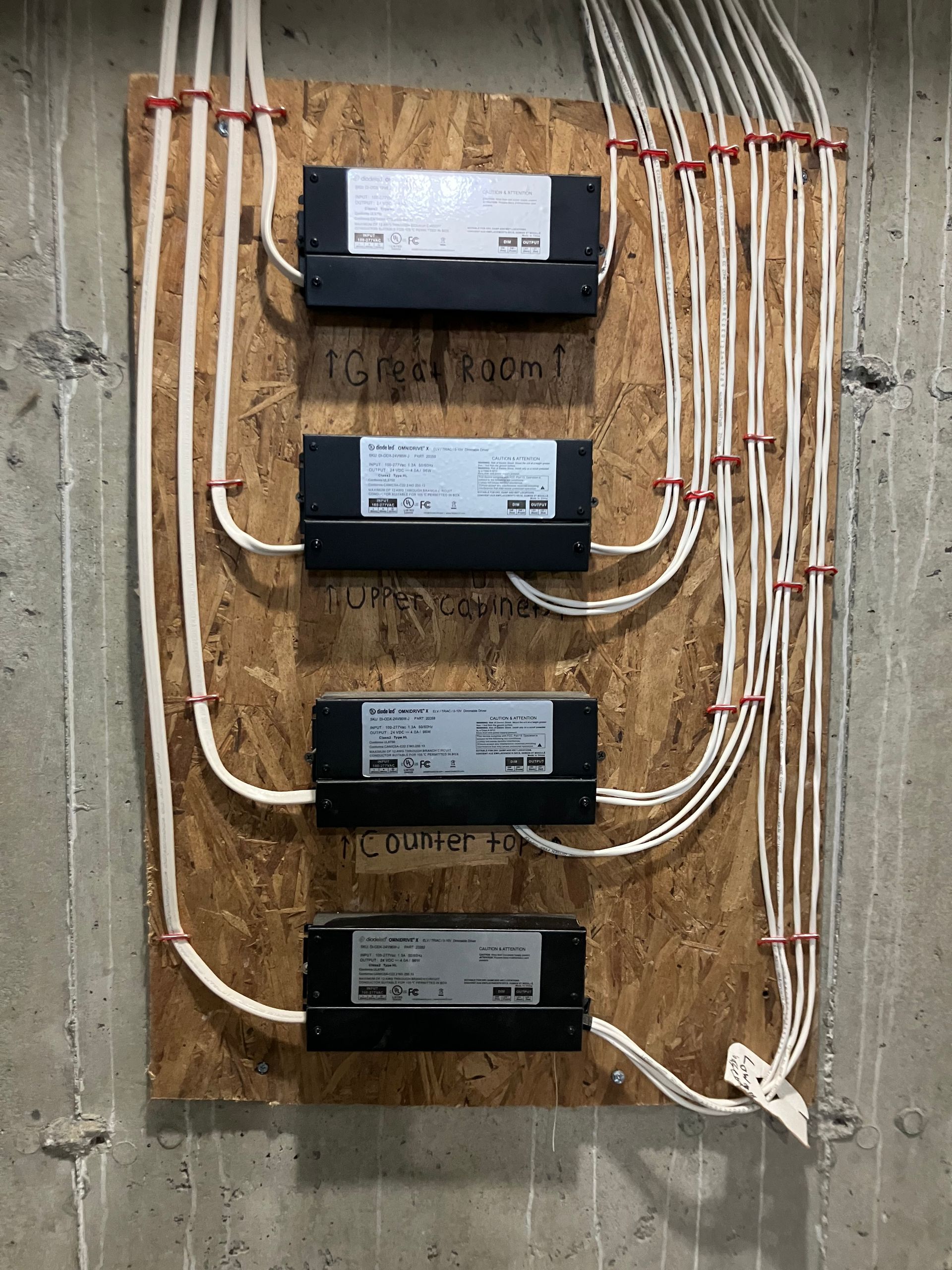 A wooden board with a bunch of wires attached to it