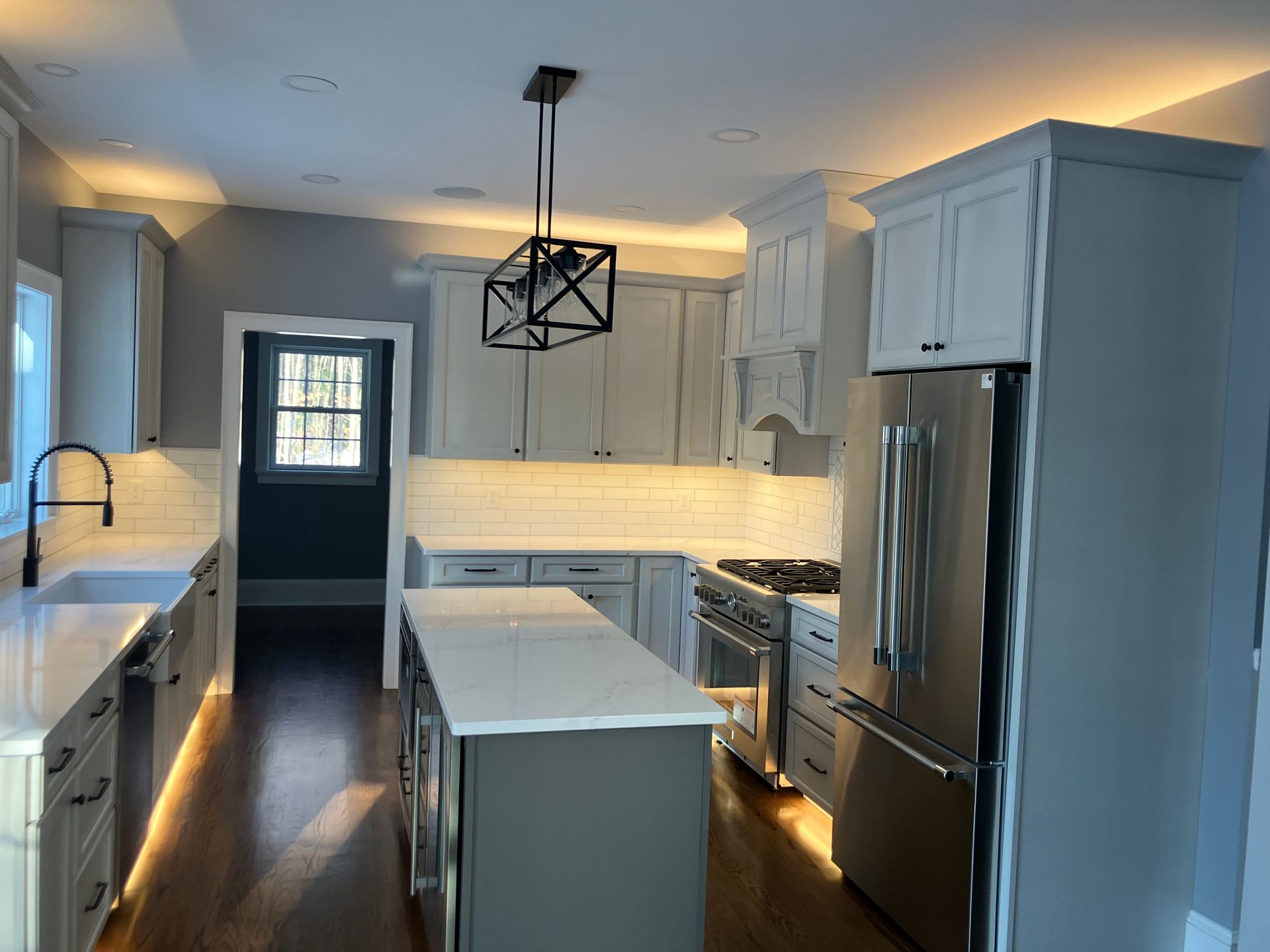 A kitchen with white cabinets and stainless steel appliances