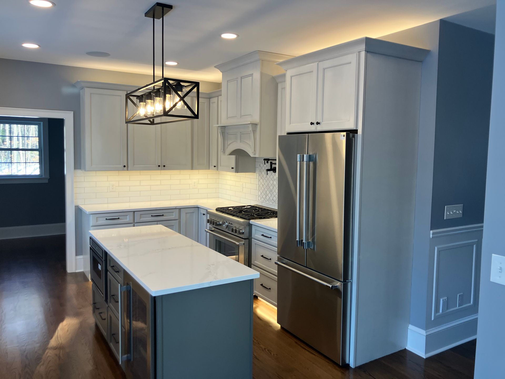 A kitchen with stainless steel appliances and white cabinets