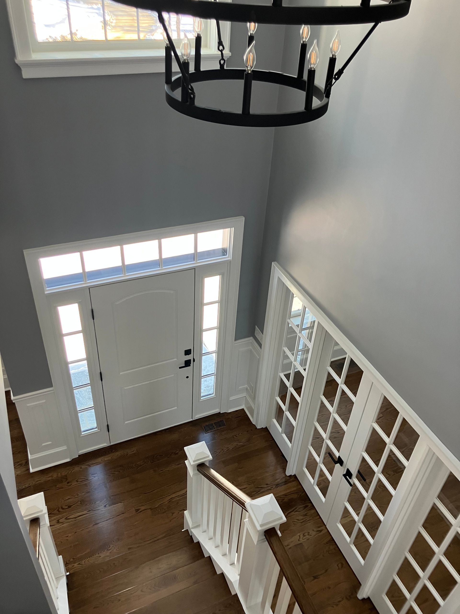 An aerial view of a hallway with a chandelier hanging from the ceiling.
