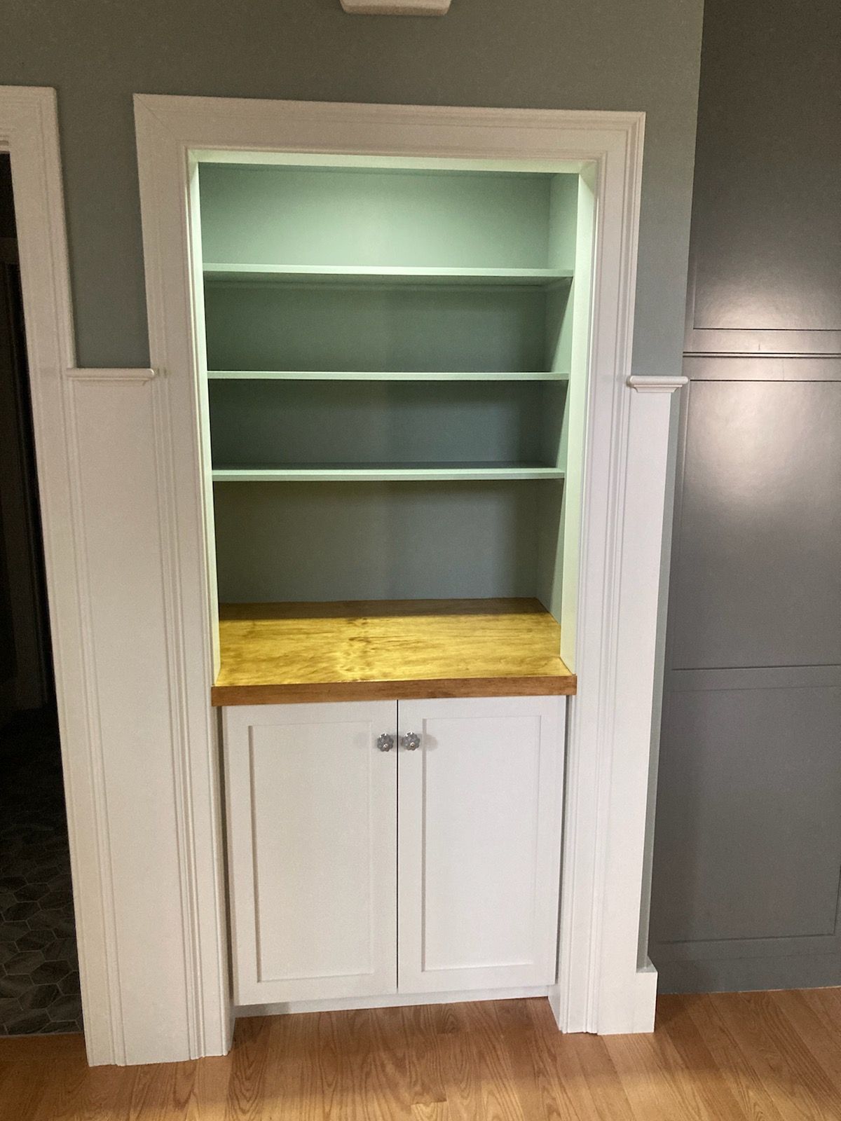 There is a bookshelf in the corner of the room.