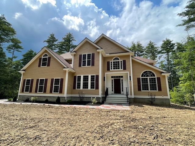 A large house with a lot of windows and shutters