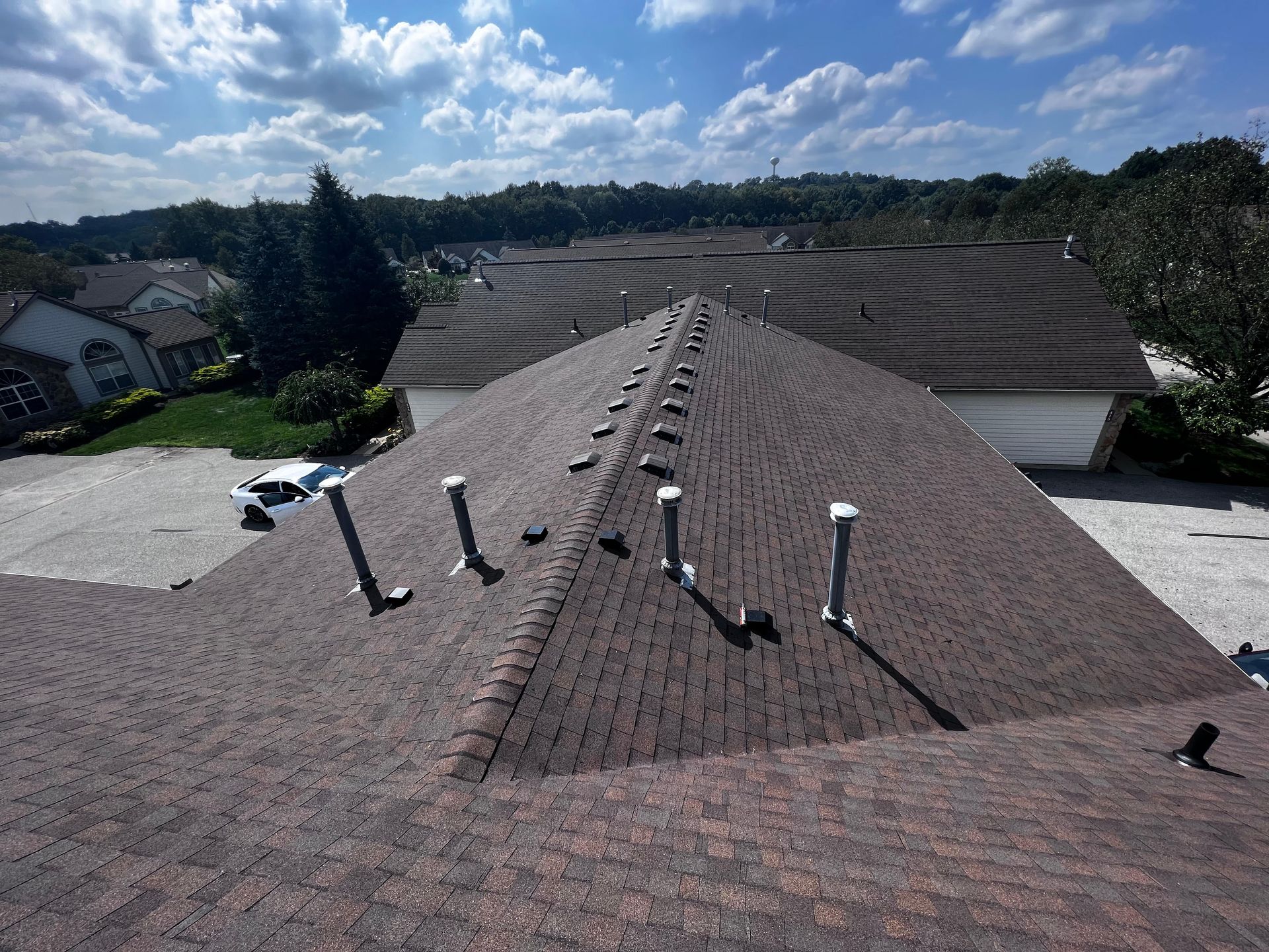 An aerial view of a roof with a lot of chimneys on it