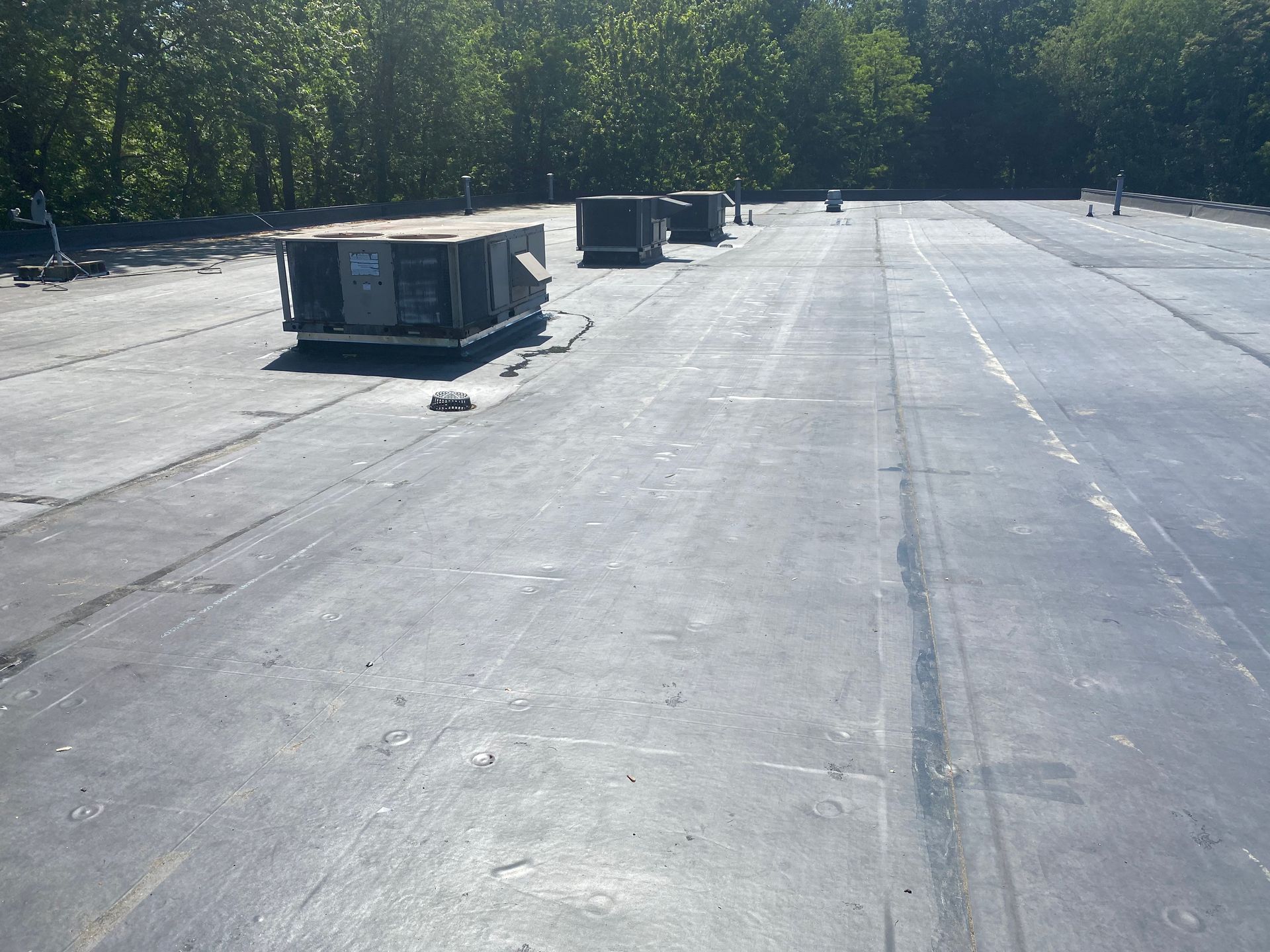 A rooftop with a lot of air conditioners on it