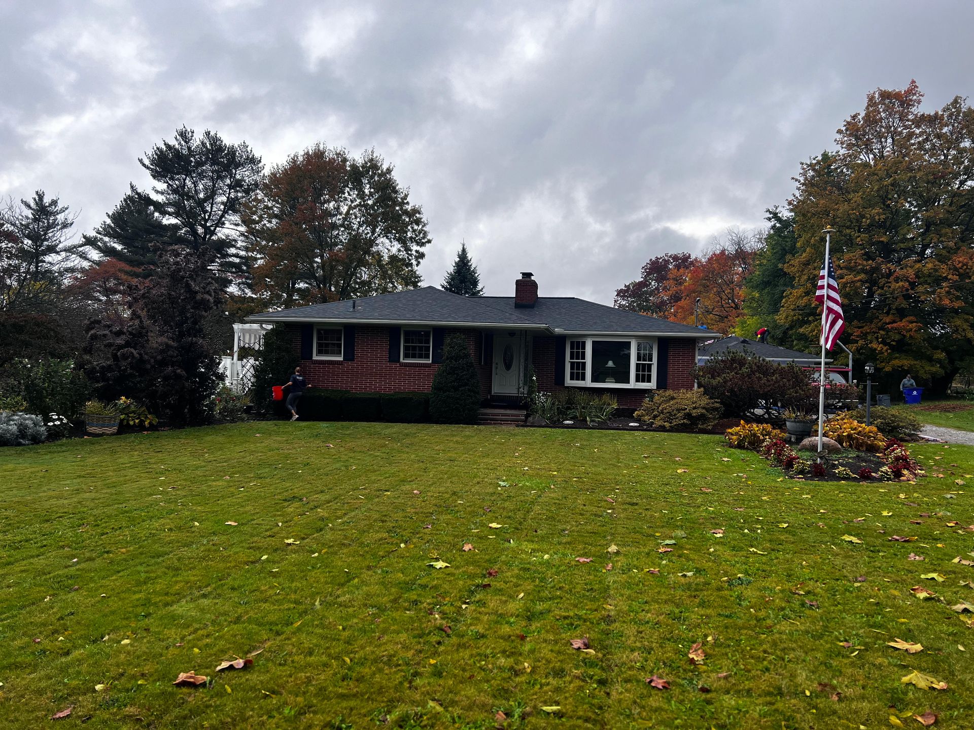 A house with a flag in front of it on a cloudy day