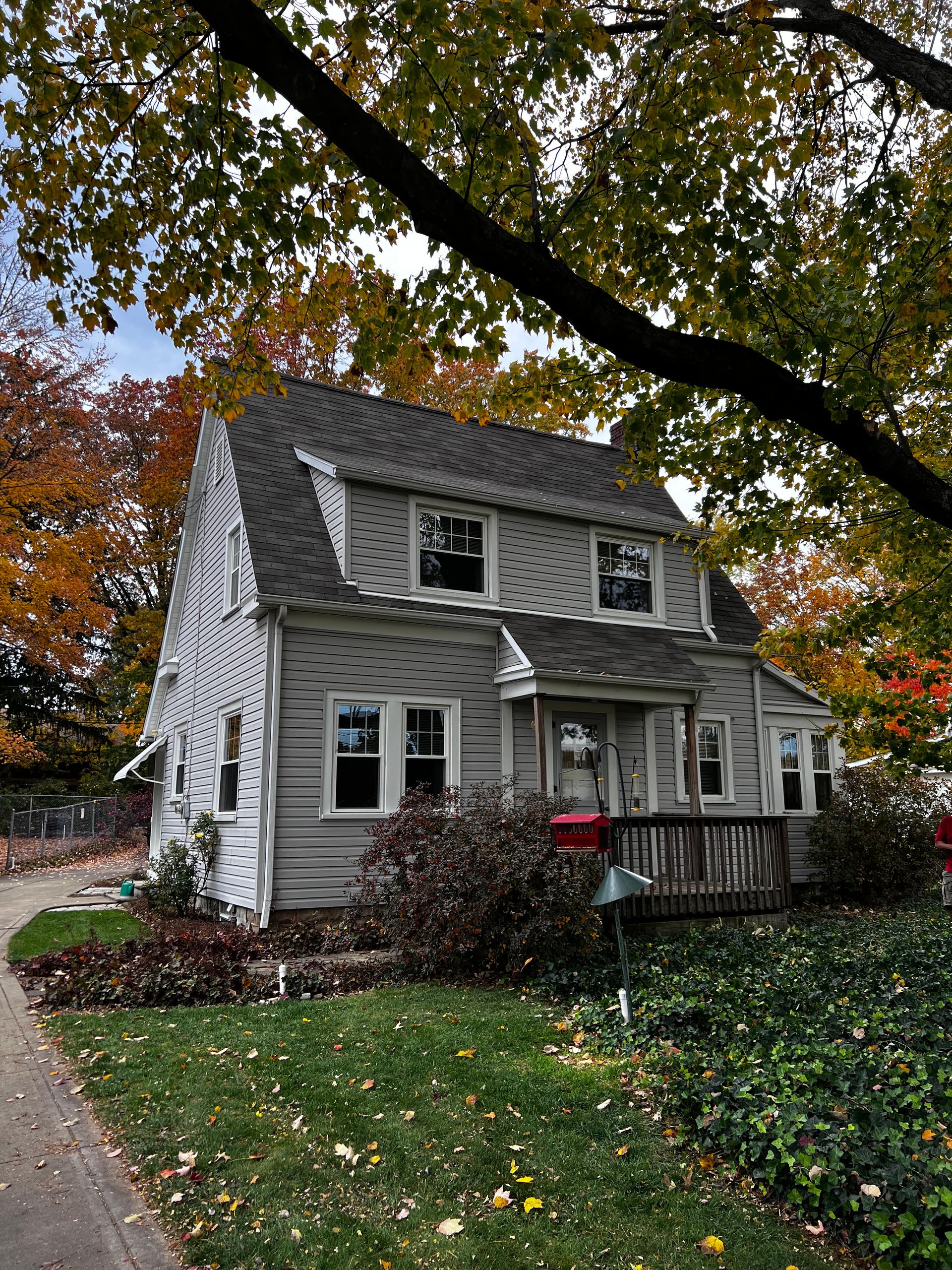 A small house with a red mailbox in front of it