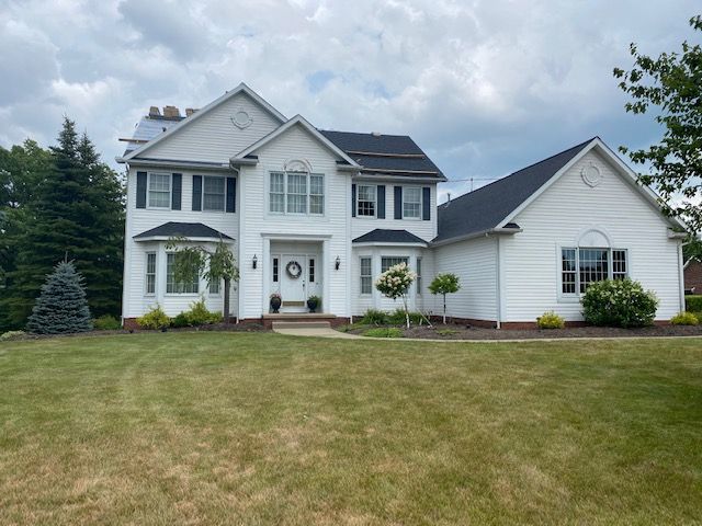 A large white house with a black roof