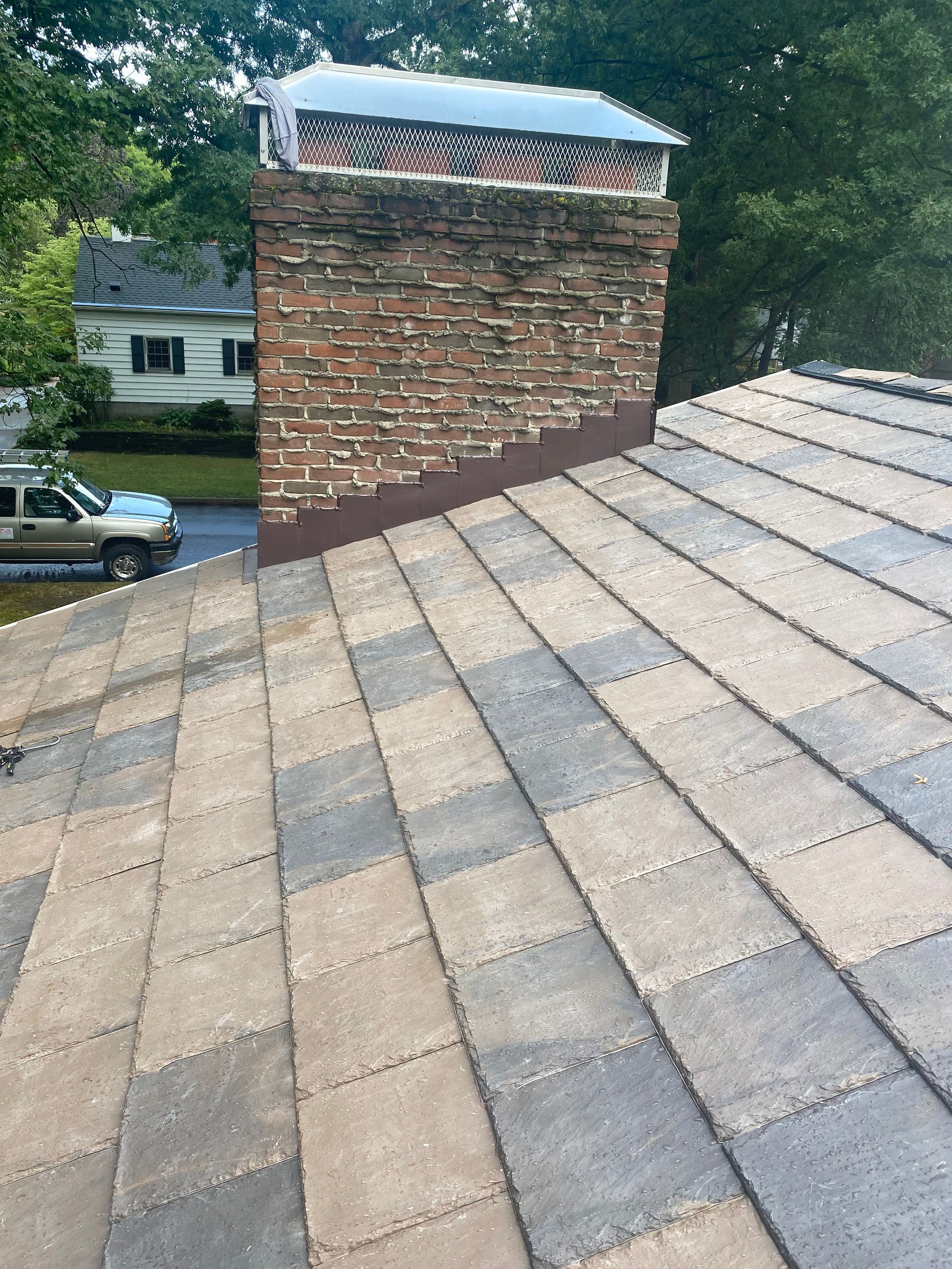A roof with a brick chimney on top of it