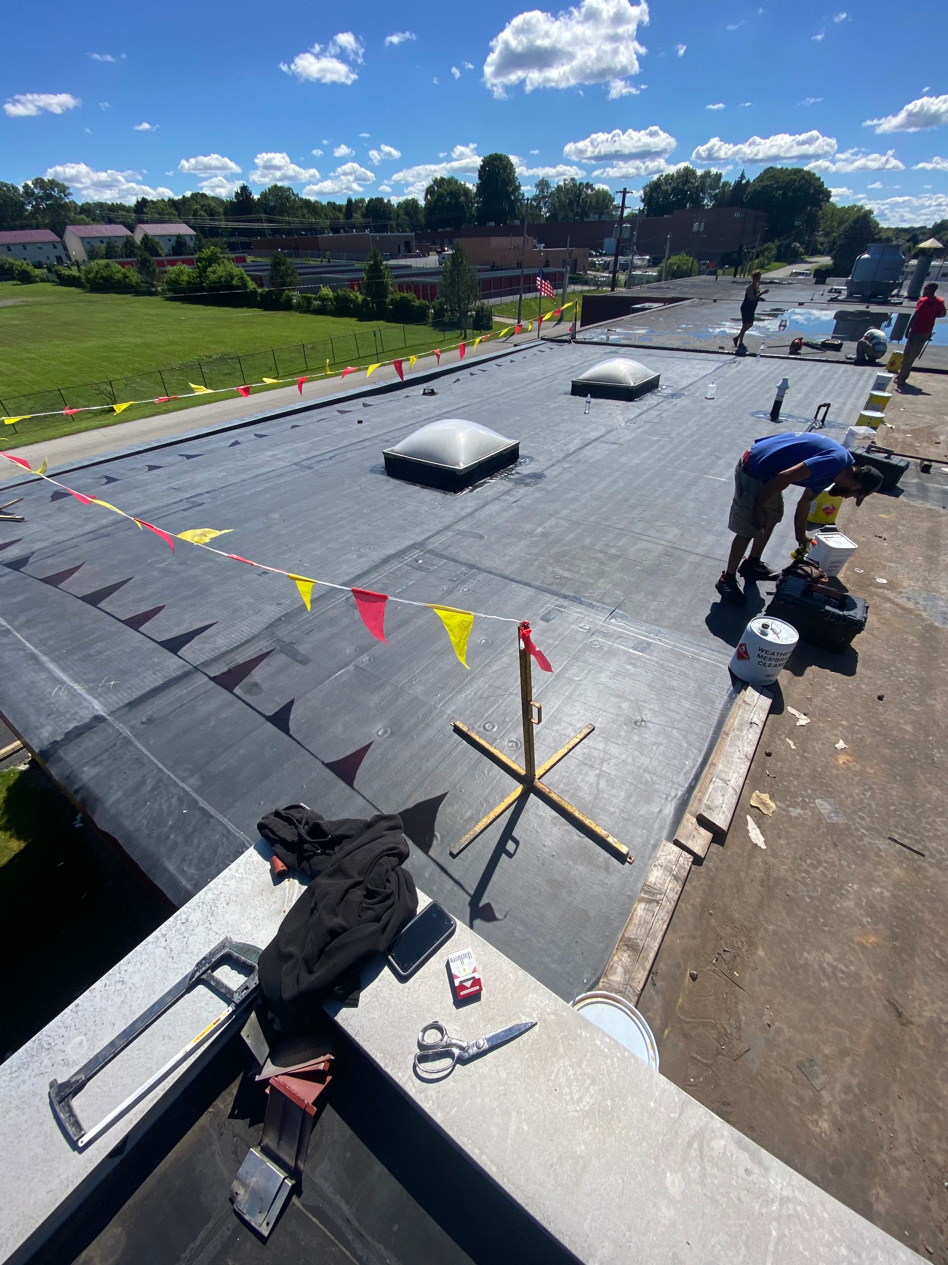A group of people are working on a roof.