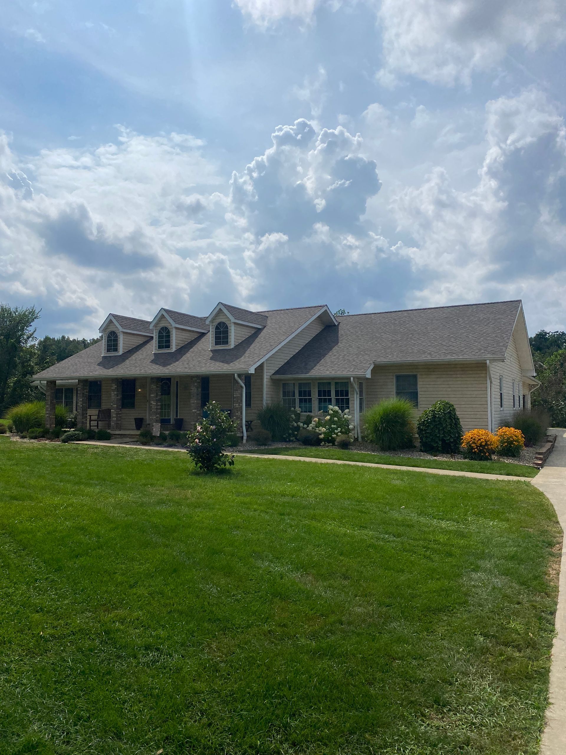 A large house with a lush green lawn in front of it.
