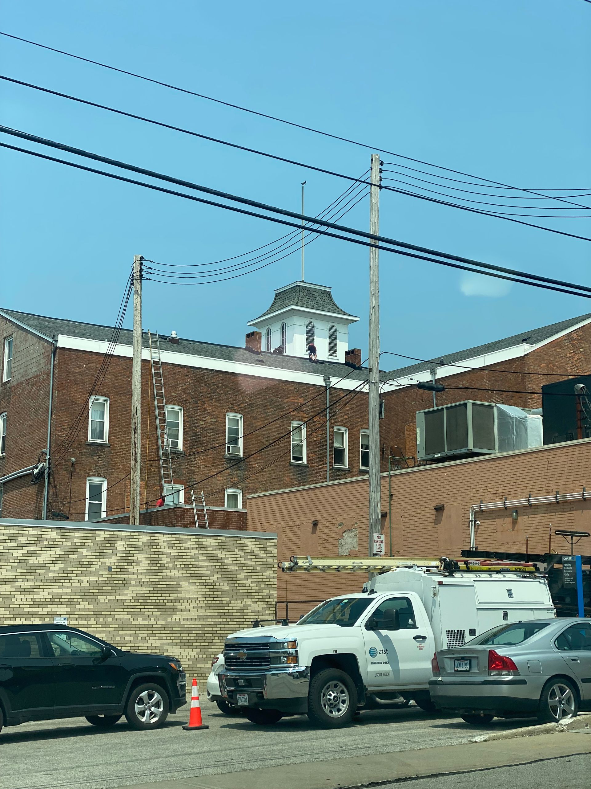 A brick building with cars parked in front of it