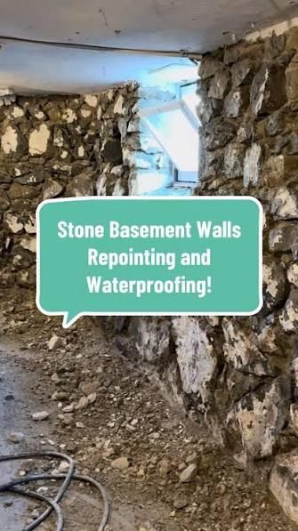 An unfinished stone basement wall with debris on the floor and a text overlay reading 