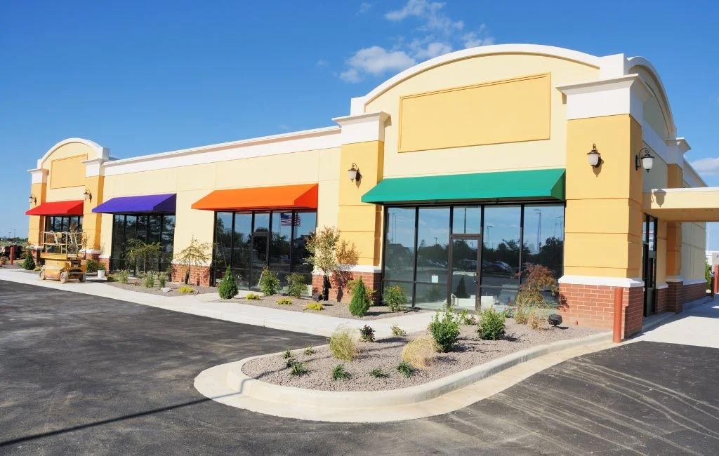 A yellow building with a lot of windows and awnings