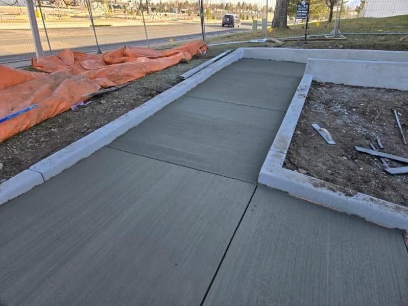 A concrete walkway is being built next to a road.