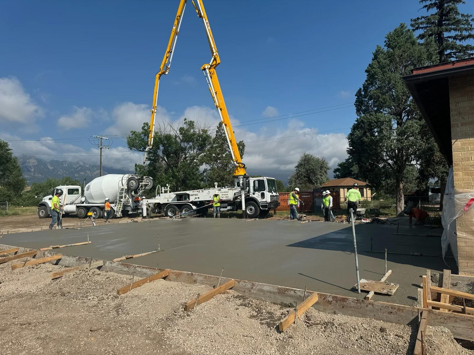 A concrete pump is being used to pour concrete on a construction site