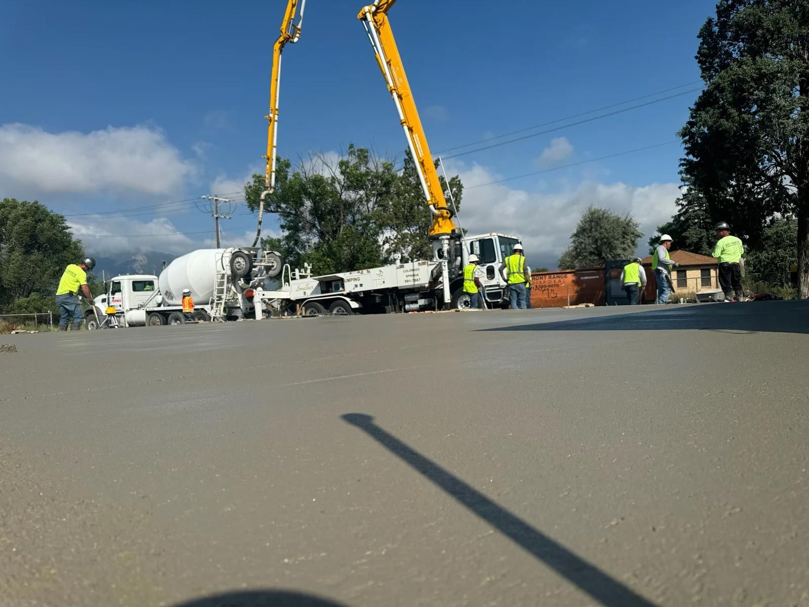 A group of construction workers are working on a road.