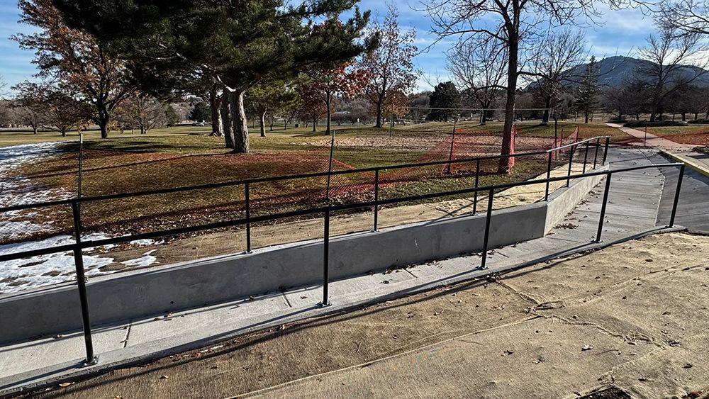 There is a ramp in the park with a railing.