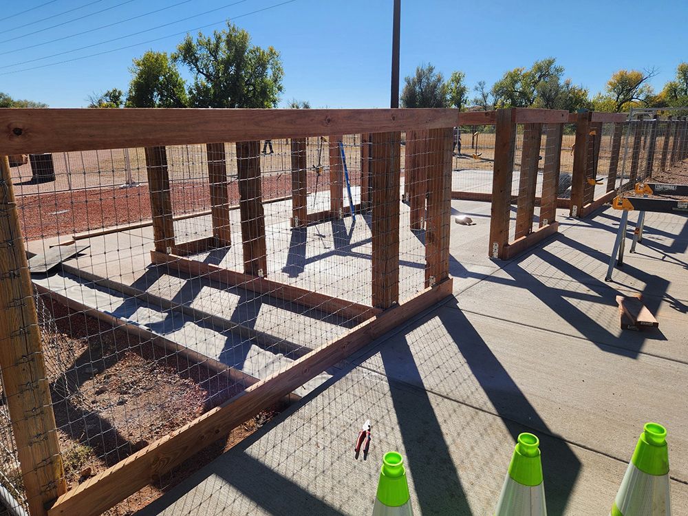 A wooden fence is being built in a park