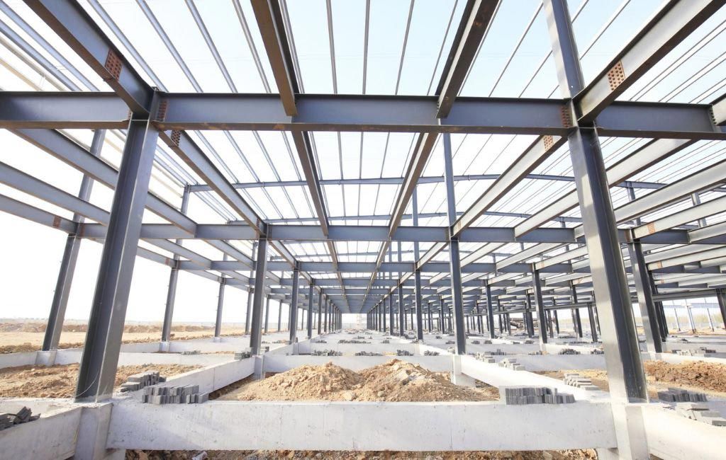 A large building under construction with a lot of metal beams.