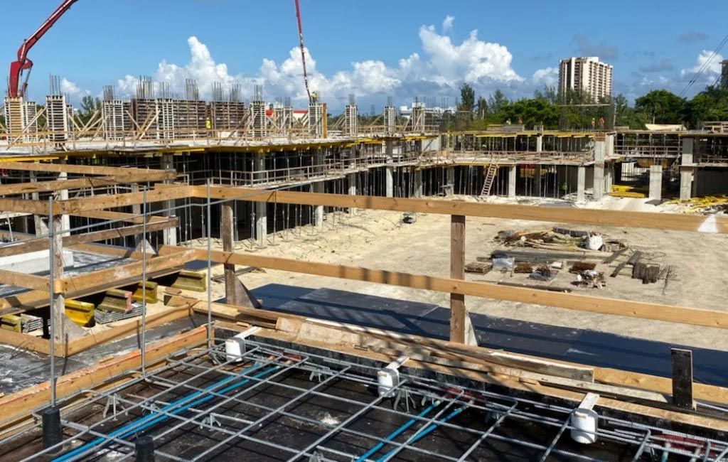 A large building under construction with a crane in the background.