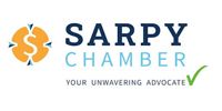 Sarpy Chamber logo in blue and orange with the tagline “Your Unwavering Advocate” and a green checkmark