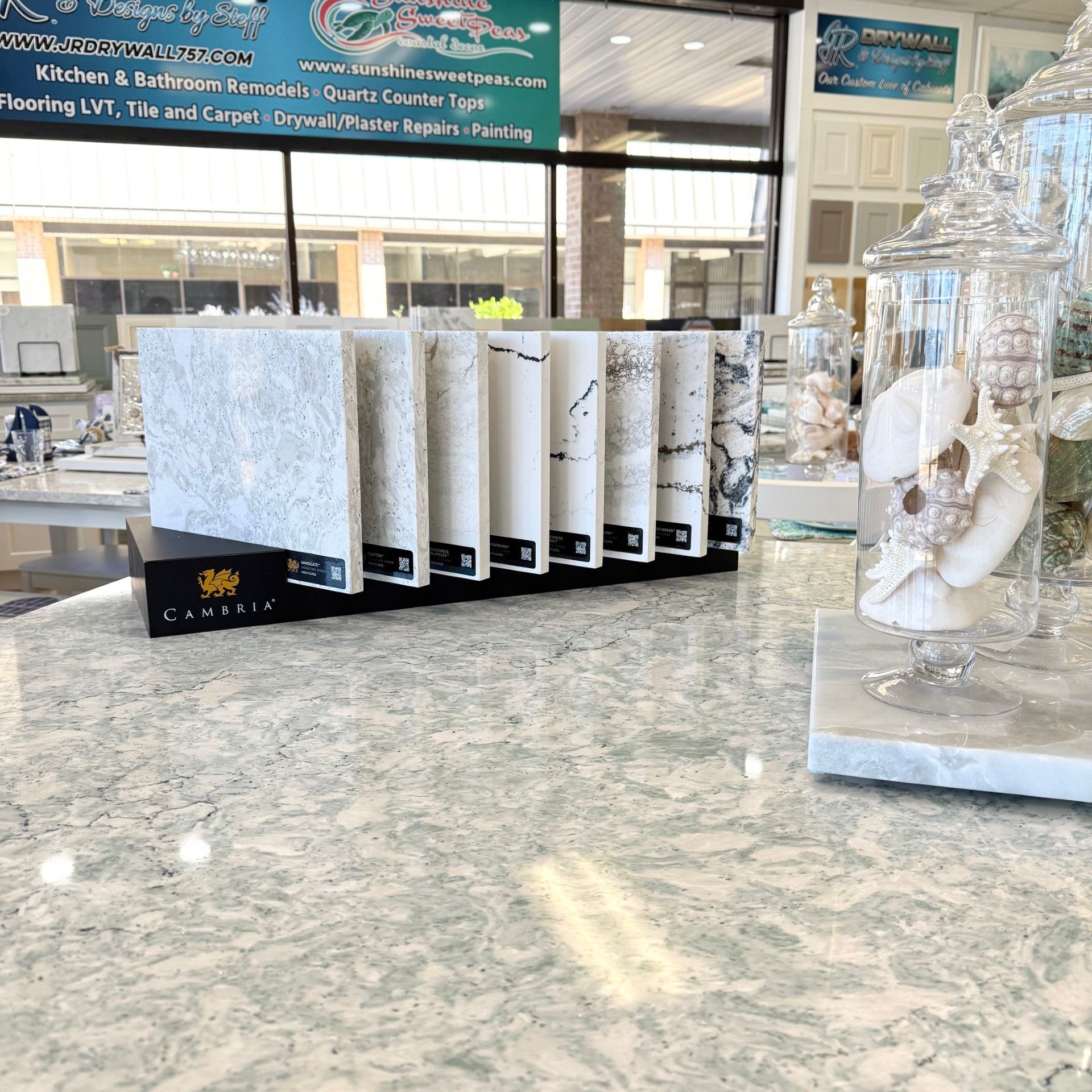 Countertop display with stone samples in showroom setting.